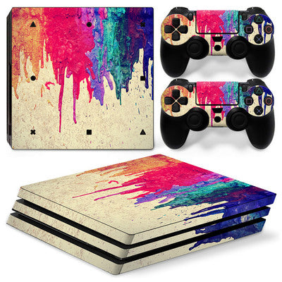 Gaming console and controllers with colorful abstract skin design on a white background