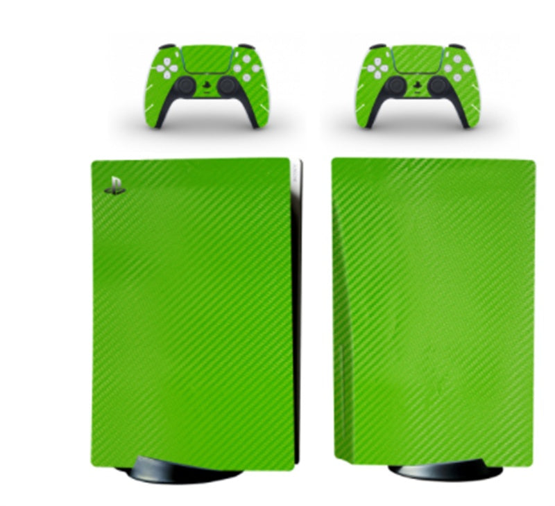 Green carbon fiber patterned gaming console and controllers on a white background
