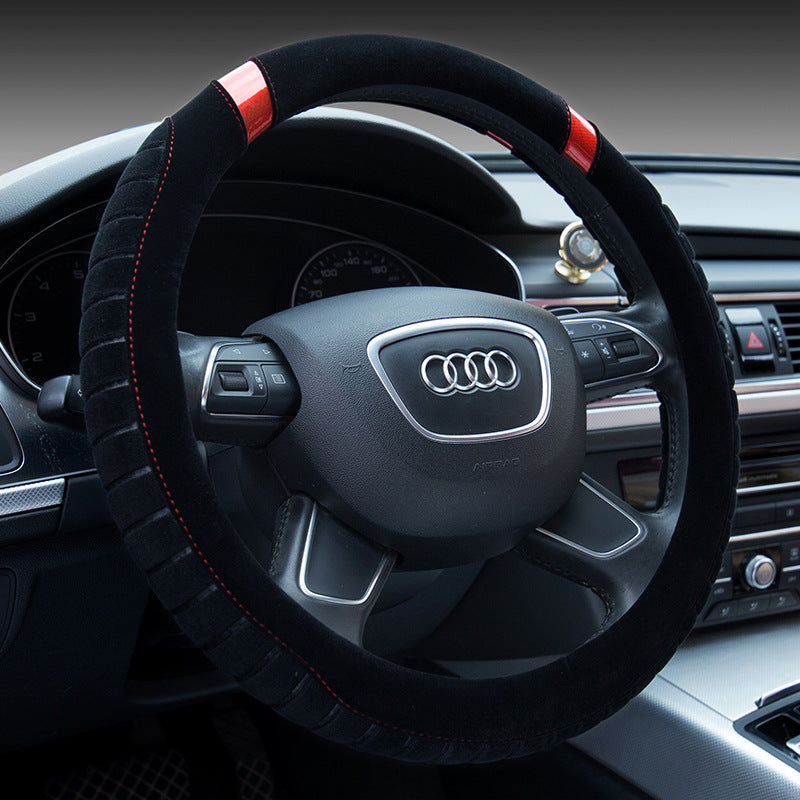 Steering wheel of an Audi car with a black cover and red stitching.