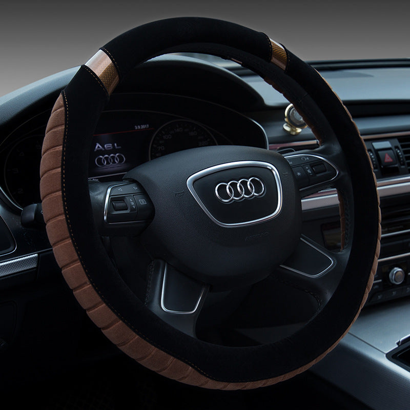 Steering wheel of an Audi car with a black and brown cover.