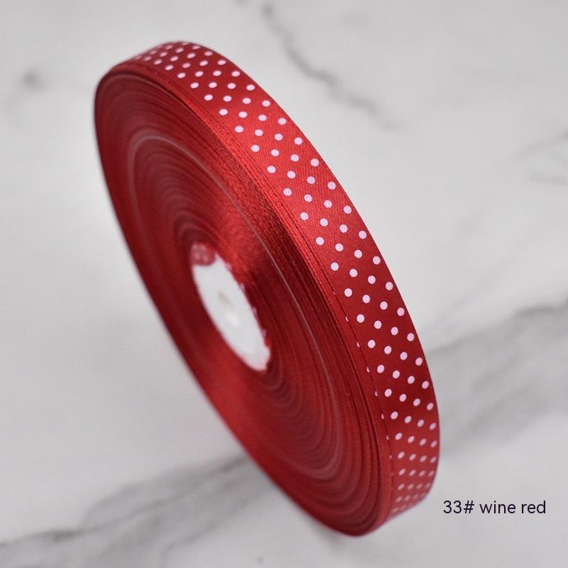Handmade decorative bows featuring classic polka dot patterns on premium grosgrain ribbon for gift wrapping and accessories