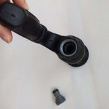 Black mechanical component held by a hand on a white background