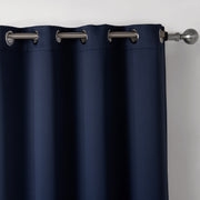 Navy blue curtain with silver grommets on a plain background