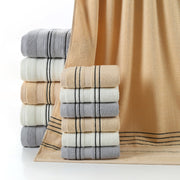 Stacks of folded towels in various colors on a white background