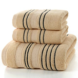 Stack of beige towels with black stripes on a white background
