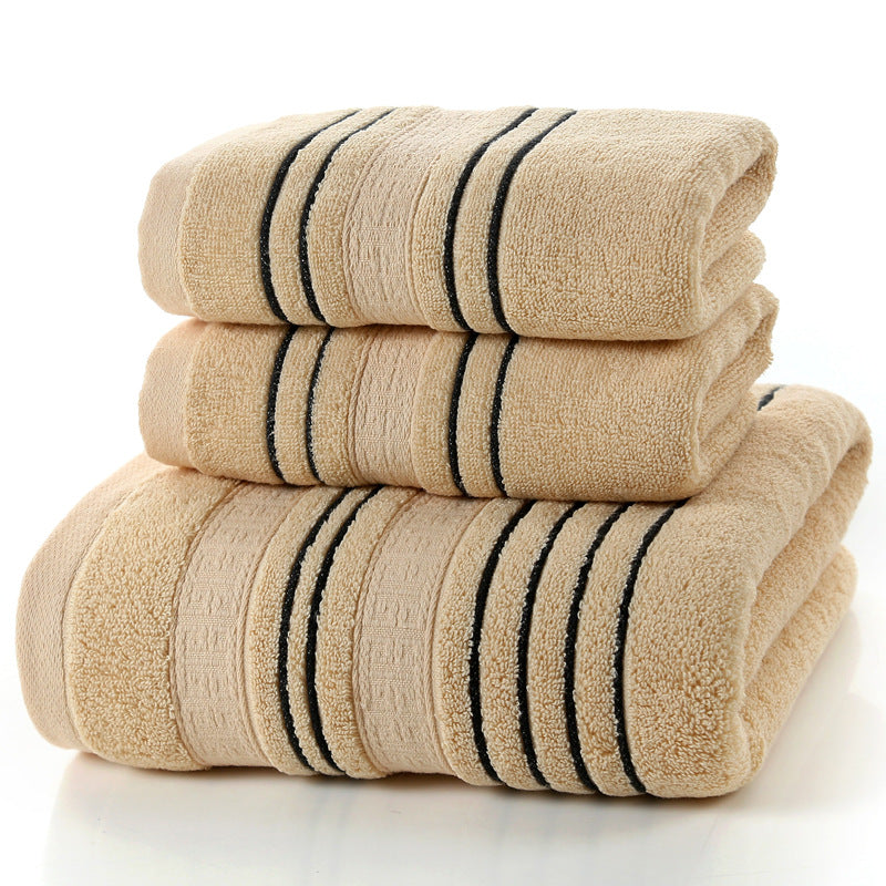 Stack of beige towels with black stripes on a white background