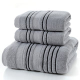 Stack of gray towels with black stripes on a white background