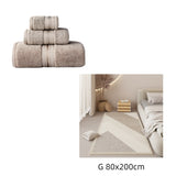 Beige towels with striped design on a white background, followed by a bedroom scene with a beige rug.