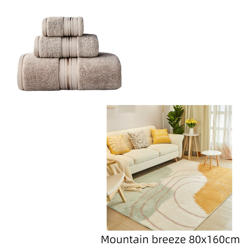 Set of towels with a living room scene featuring a rug labeled 'Mountain breeze 80x160cm'.