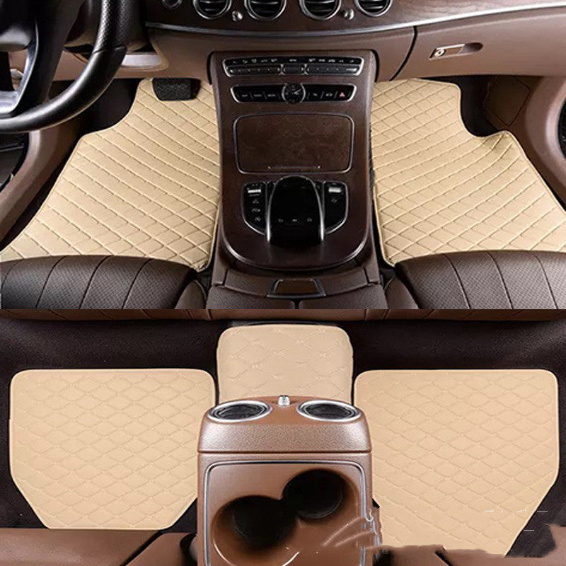 Car interior with beige floor mats covering the floor and console area.