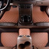Brown car floor mats with diamond pattern on a car interior.