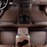 Brown car interior with quilted design on floor mats and center console.