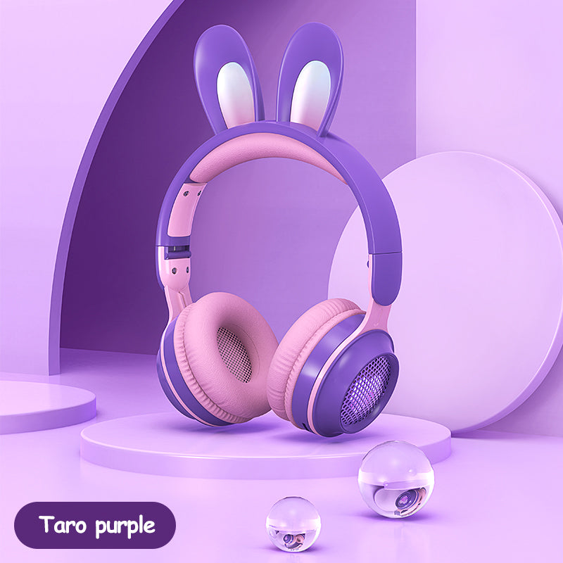 Pink and purple headphones with bunny ears on a purple background
