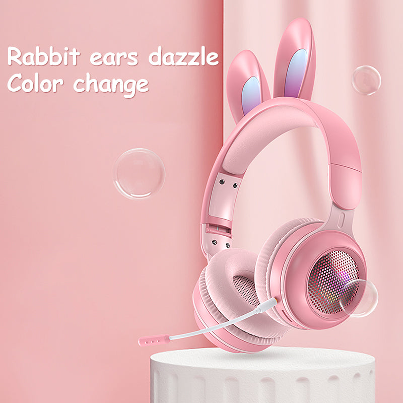 Pink headphones with bunny ears on a pink background