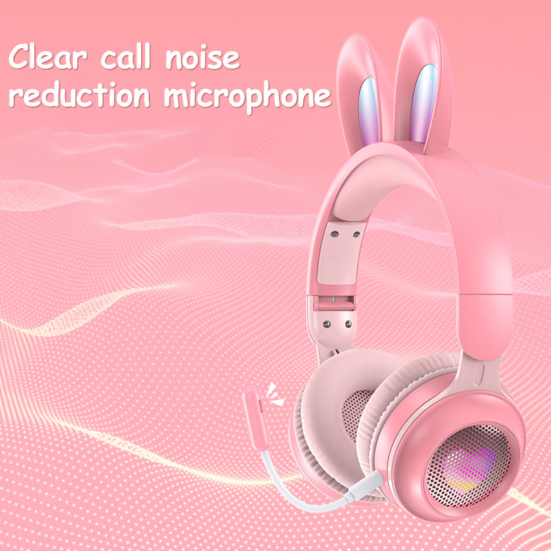 Pink headphones with bunny ears on a pink background, featuring text about clear call noise reduction microphone.