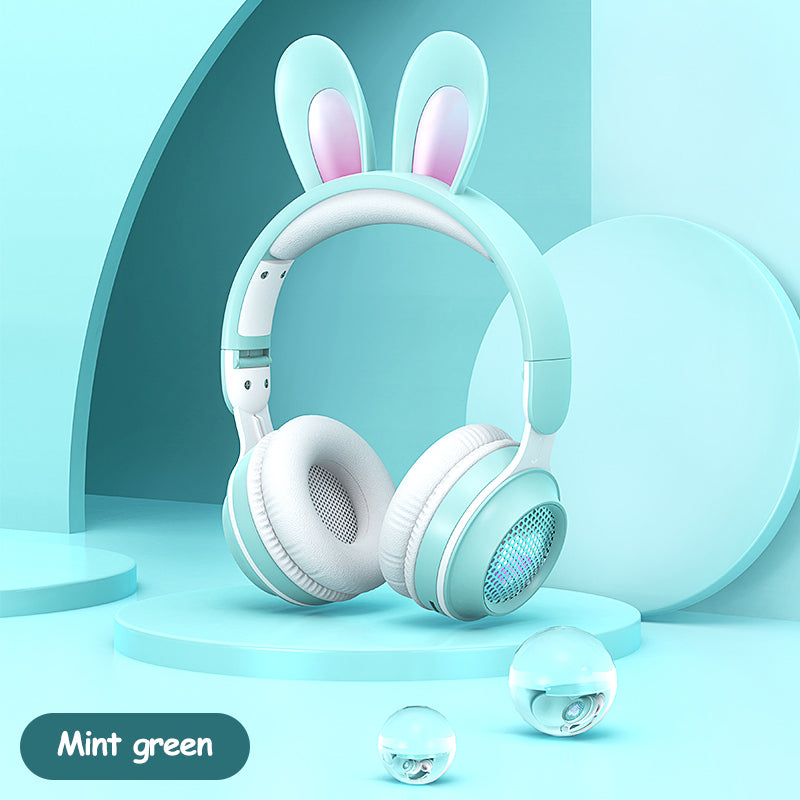 Mint green headphones with bunny ears on a light blue background