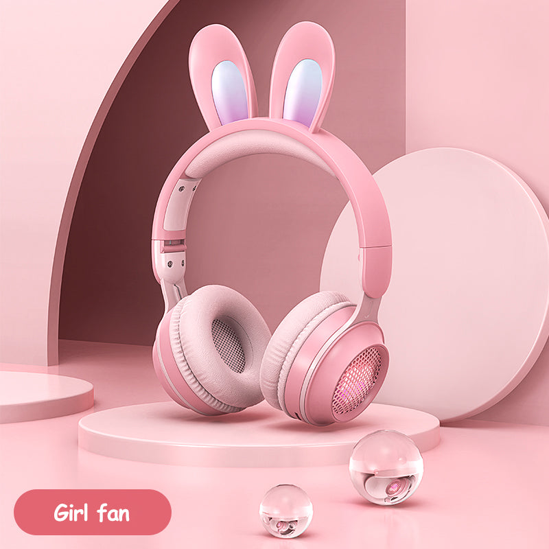 Pink headphones with bunny ears on a pink background