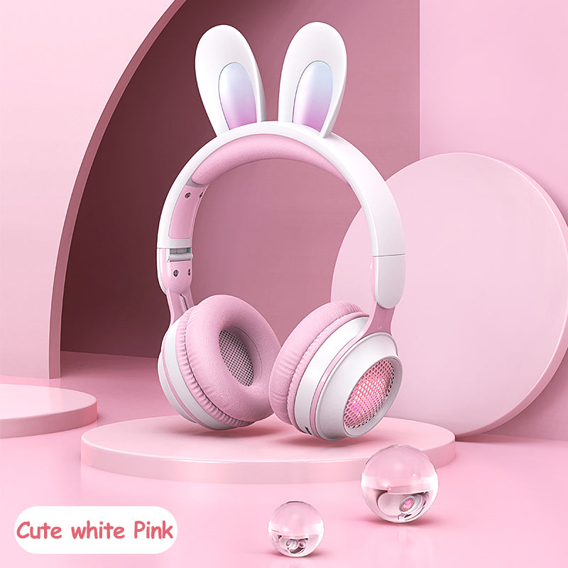 Pink and white headphones with bunny ears on a pink background