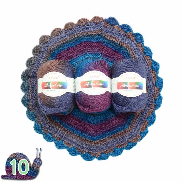 Three skeins of yarn in purple and blue shades on a matching crochet dish with 'Rainbow' label.