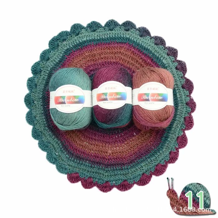 Three skeins of yarn in green and brown on a crocheted dish with a snail logo in the corner.