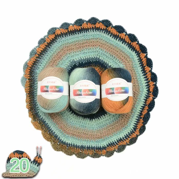 Crocheted yarn bowl with three skeins of yarn and a small knitted item on a white background