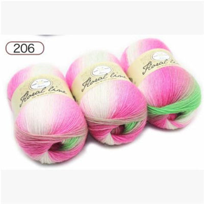 Three balls of pink and green yarn with labels on a white background