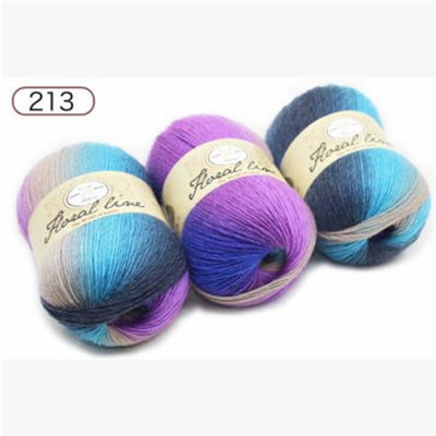 Three skeins of yarn with gradient colors on a white background