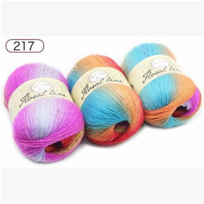 Four balls of colorful yarn with brand labels on a white background