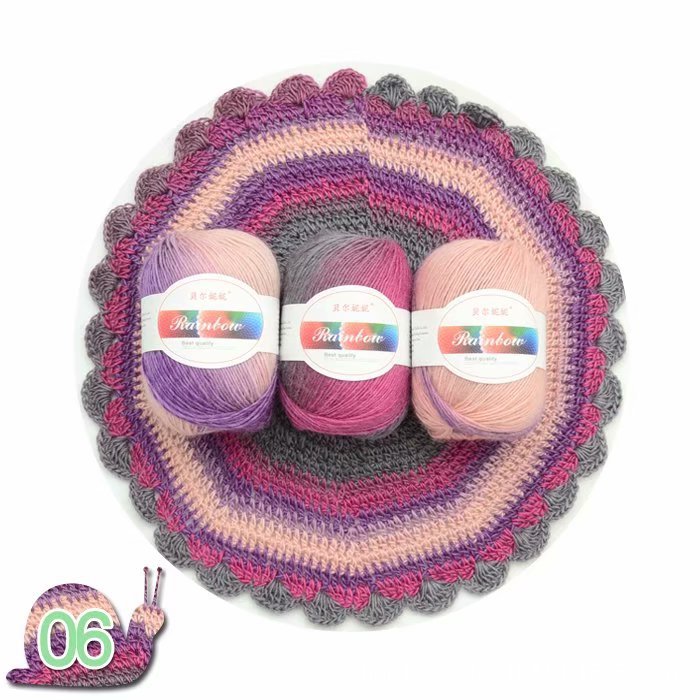 Three balls of yarn with labels on a crocheted circular mat.