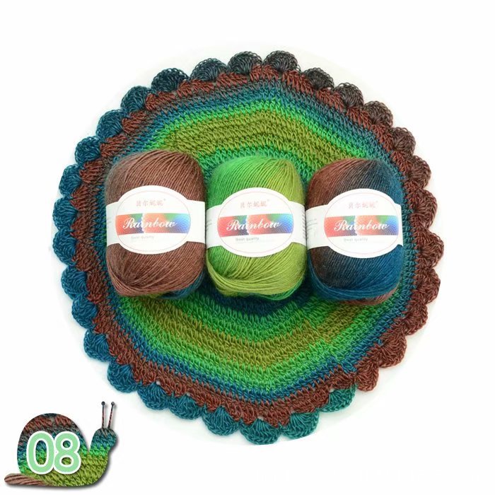 Three balls of yarn in brown, green, and blue on a crocheted dish with a white background.