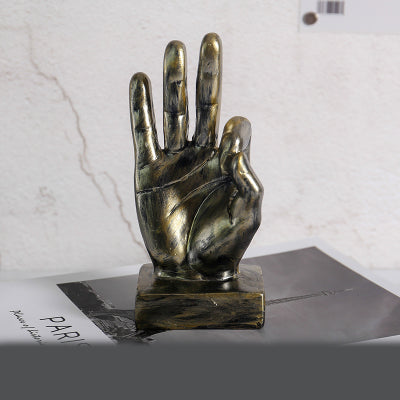 Bronze hand sculpture on a white background