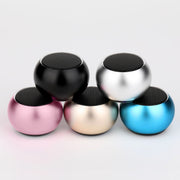 Five colorful mini speakers stacked on a light gray background