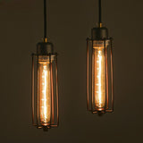 Two vintage-style light bulbs in wire cages on a dark background