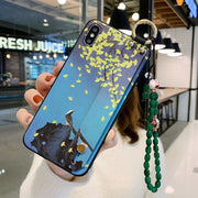 Phone case with artistic design held by a person in an indoor setting