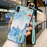 Phone case with scenic design held by a hand in an indoor setting