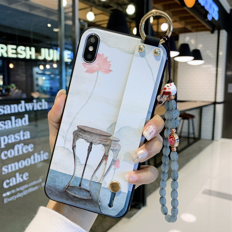 Phone case with artistic design held by a person in an indoor setting