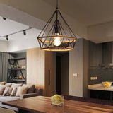 Modern living room with a pendant light fixture, sofa, and kitchen area.