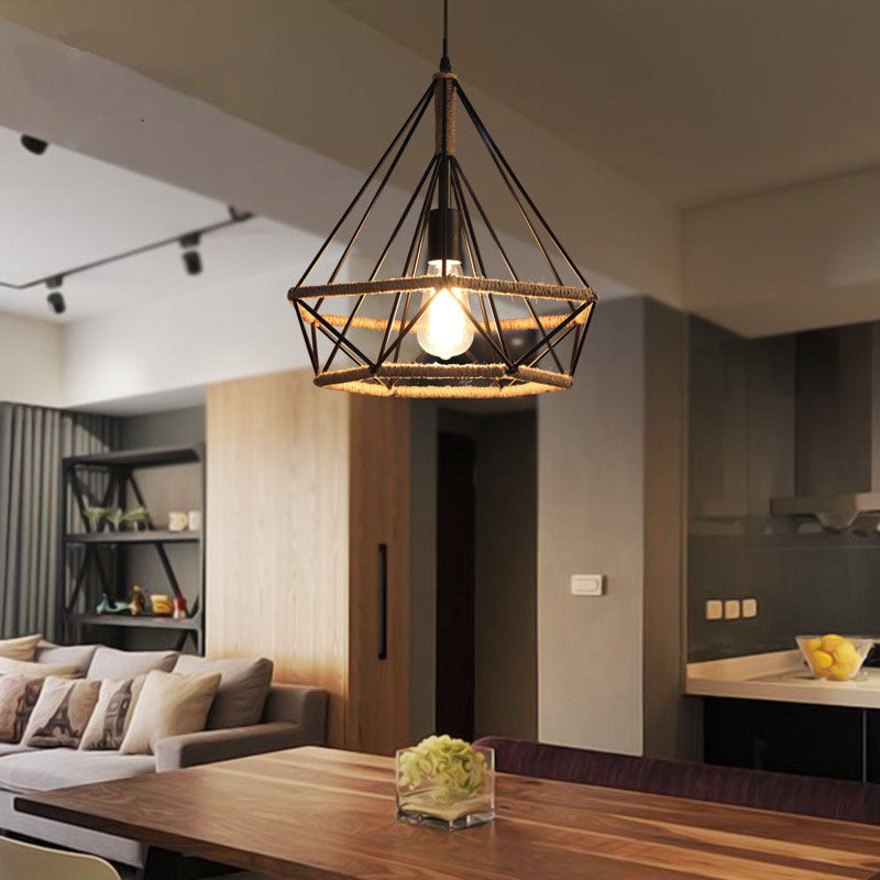Modern living room with a pendant light fixture, sofa, and kitchen area.