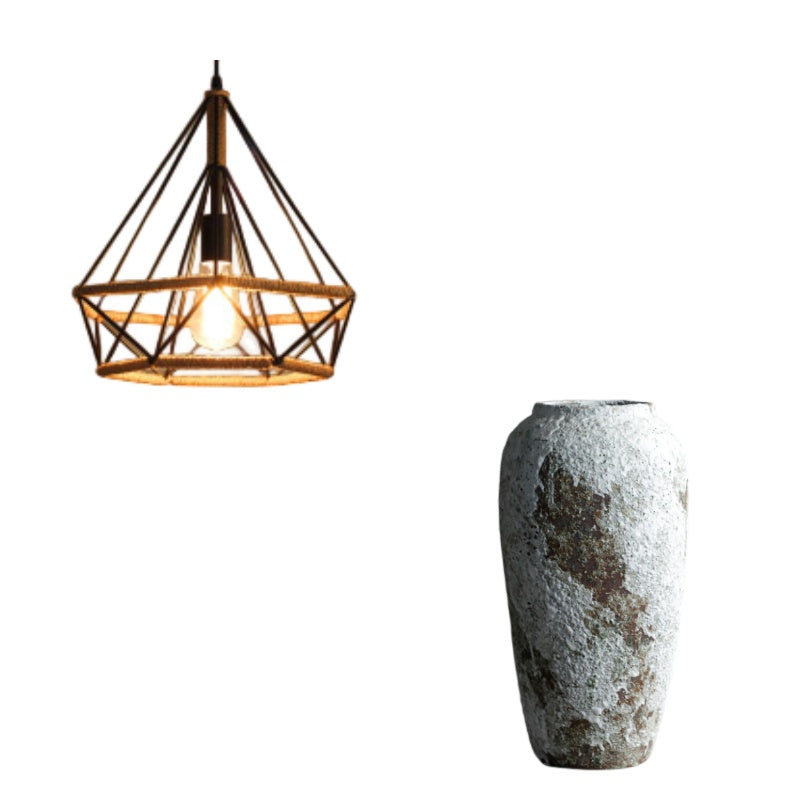 Modern pendant light with geometric cage design next to a textured stone vase on a white background