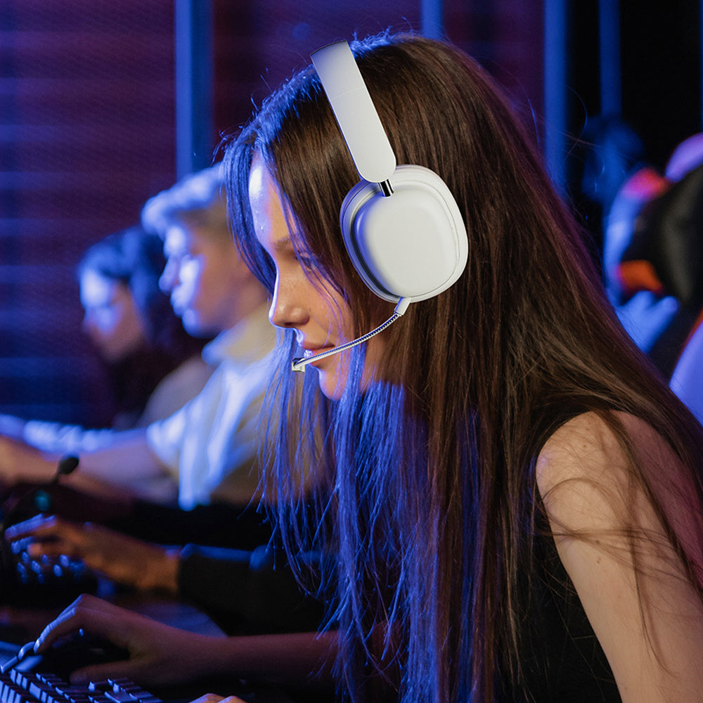 Woman wearing a white headset in an indoor setting, possibly an esports event.