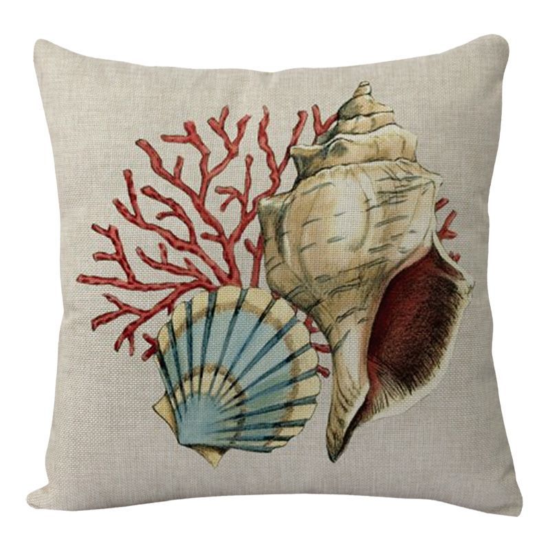 Decorative pillow with seashell and coral design on a beige background