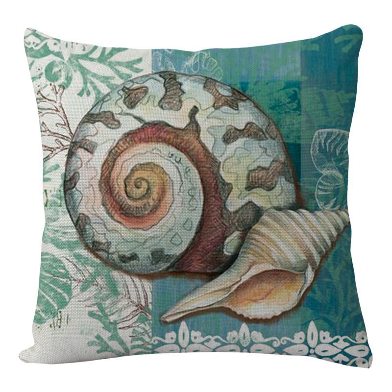 Decorative pillow with shell design on a blue and green patterned background