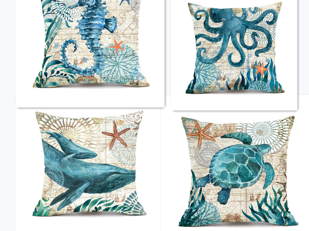 Set of four decorative pillows with ocean-themed designs on a white background.