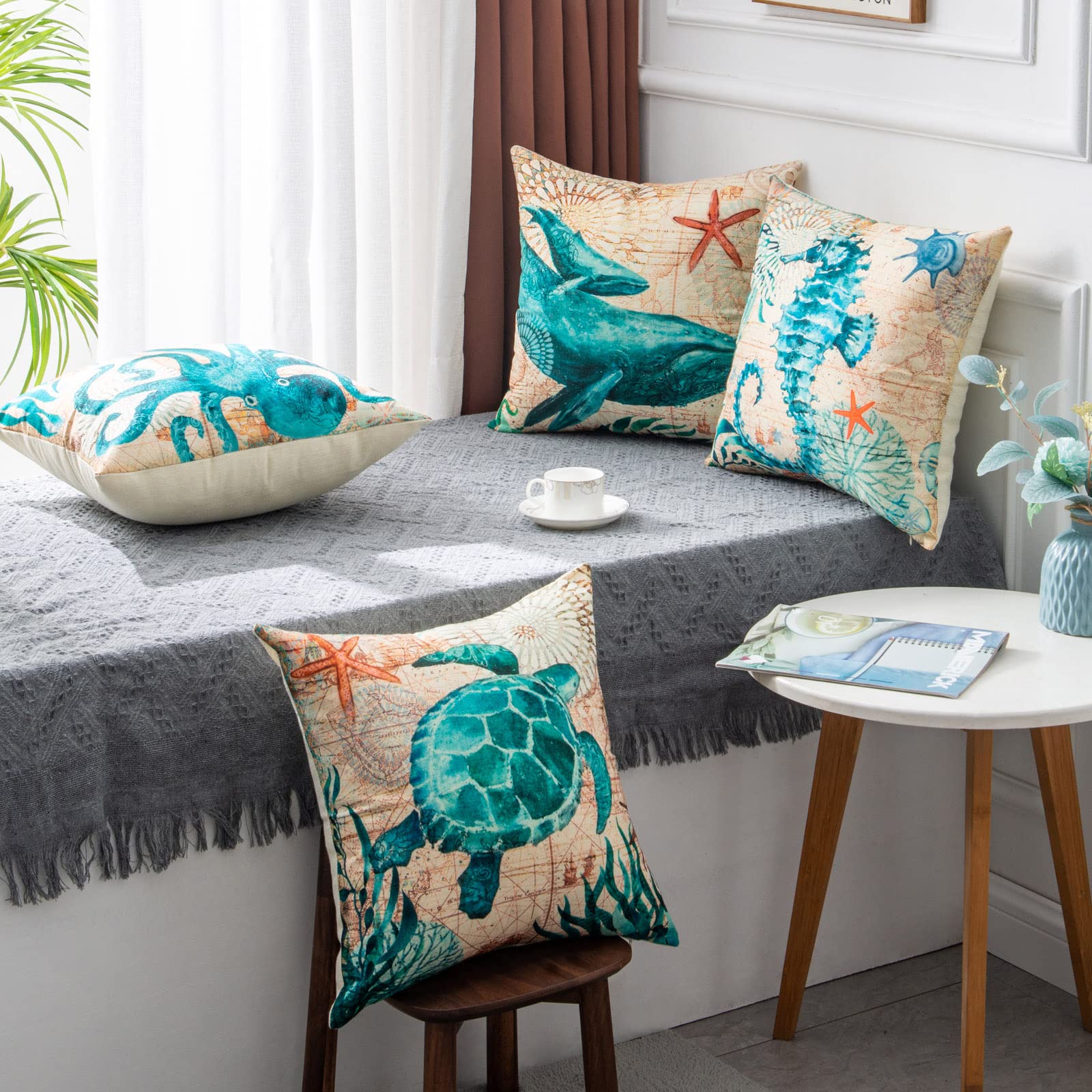 Decorative pillows with marine life patterns on a bed in a bedroom setting.