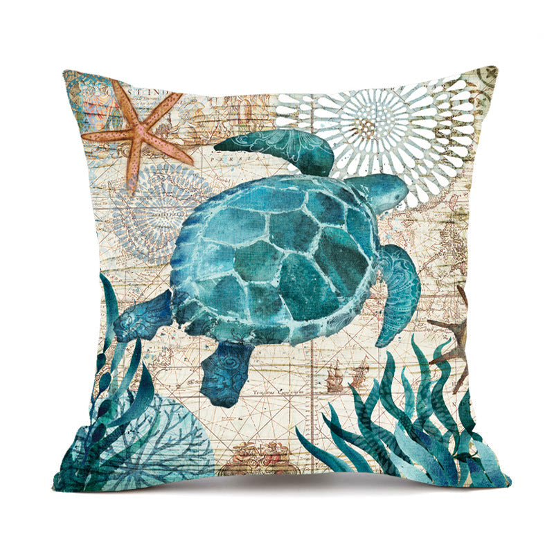 Decorative pillow with a turtle and sea-themed design on a white background