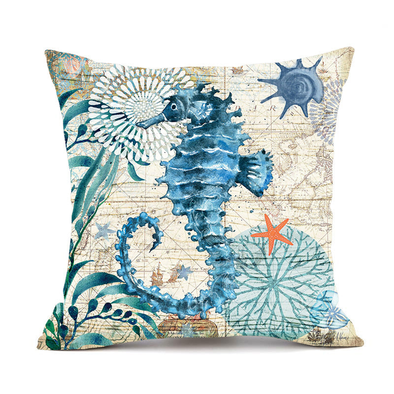Decorative pillow with a blue seahorse design on a beige background