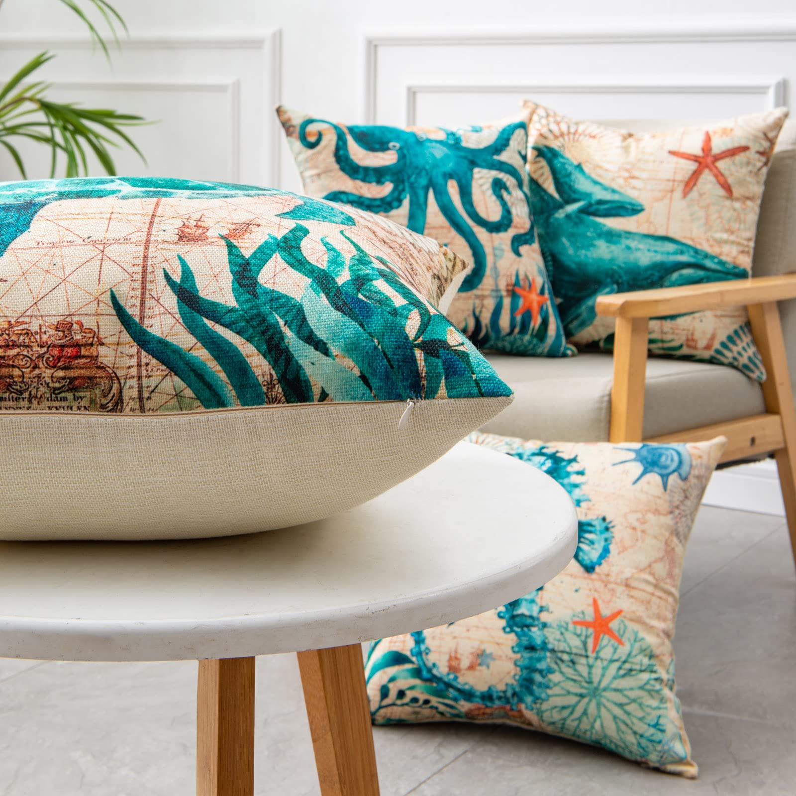 Decorative pillows with ocean-themed designs on a chair and table.