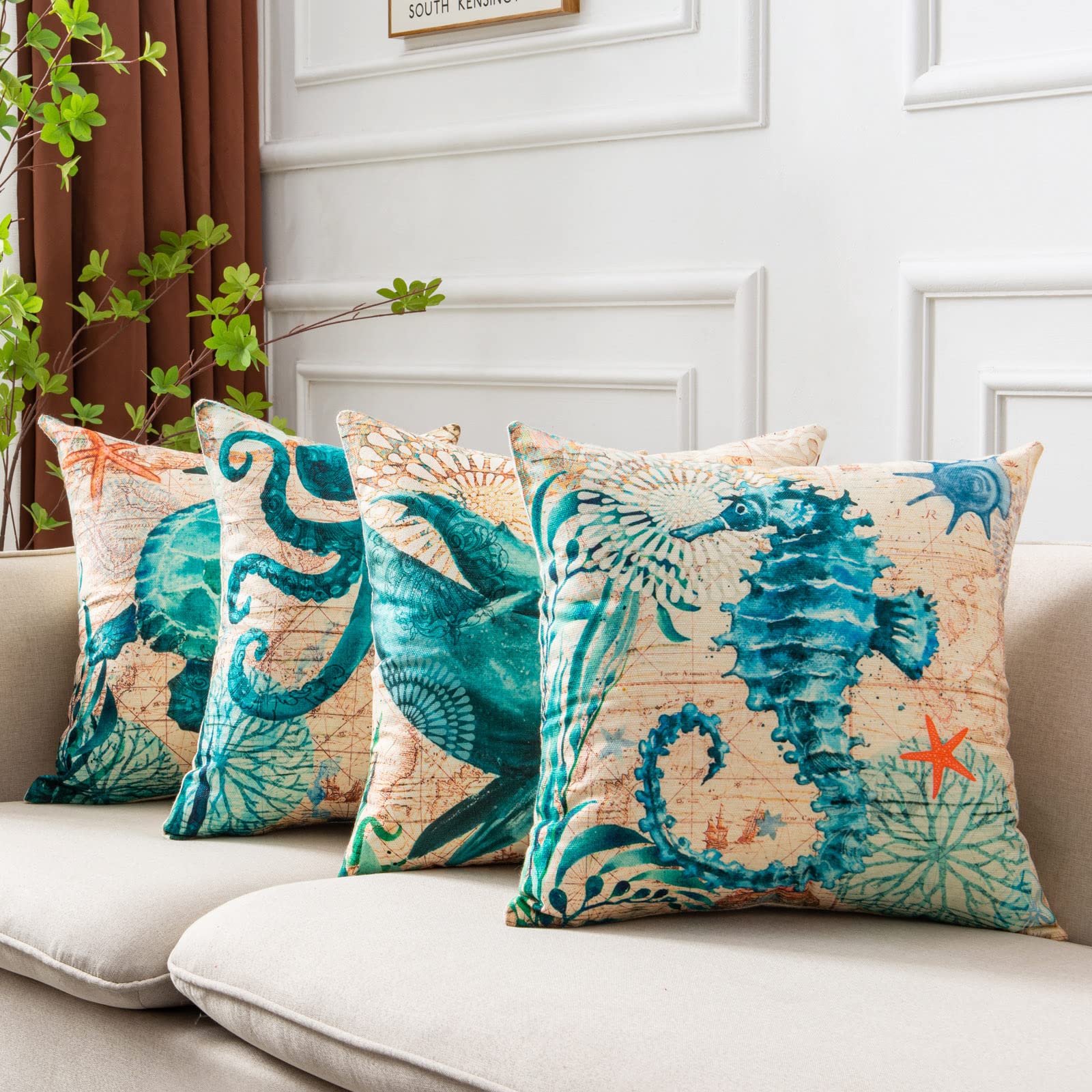 Decorative pillows with ocean-themed designs on a sofa
