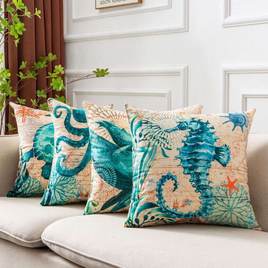 Decorative pillows with ocean-themed designs on a sofa