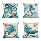 Set of four decorative pillows with ocean-themed designs on a white background.